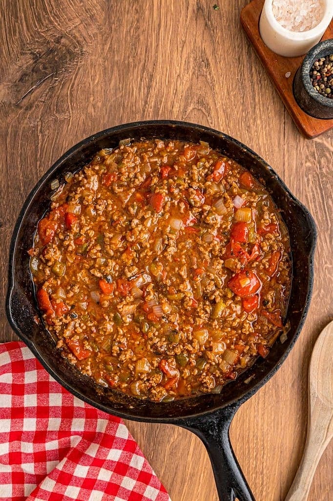 Stir in 1 packet taco seasoning, 1/4 cup water, 14.5 ounce can fire-roasted diced tomatoes, drained, and 4 ounce can diced green chilies, undrained. Let the mixture simmer for 2-3 minutes, stirring occasionally.