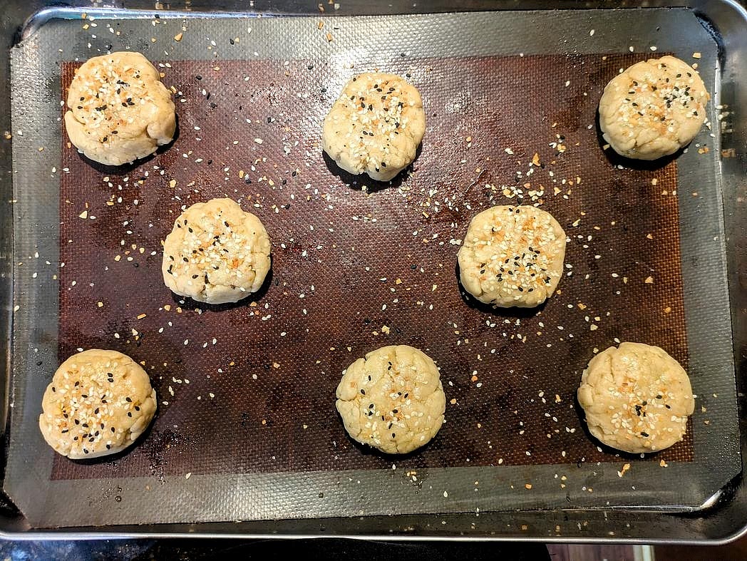 Optionally, brush the tops with oil, butter, or chicken fat. Optionally top with flaky salt, sesame seeds, or everything bagel seasoning