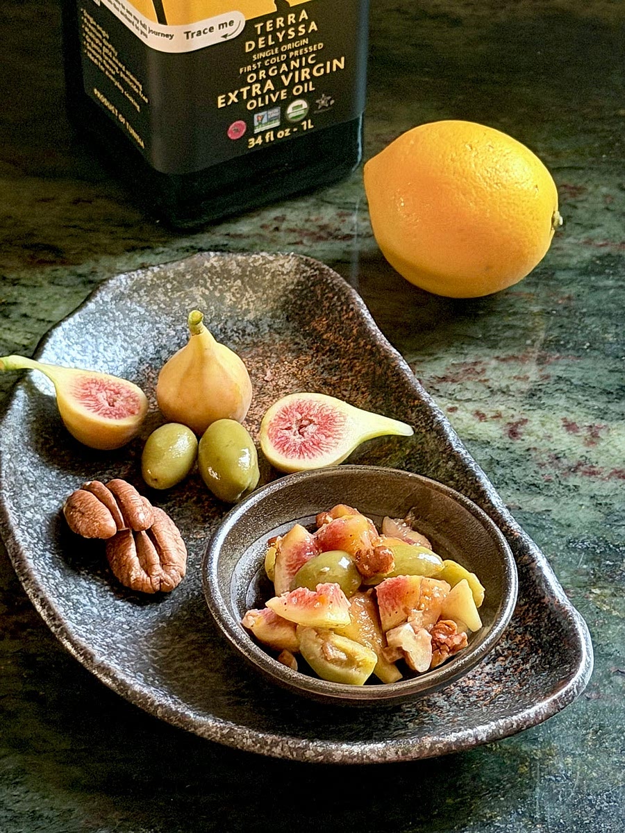 Combine the olives, lemon zest and juice, thyme, sugar, and olive oil in a bowl. Mix thoroughly.