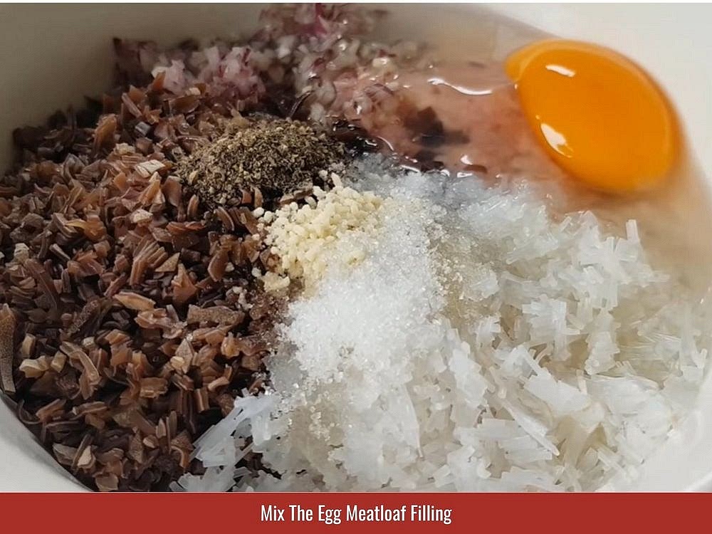 Mix The Egg Meatloaf Filling
Separate 3 of the eggs and reserve their yolks for the topping. Add the 3 egg whites and the remaining whole egg to a mixing bowl. Add the ground pork, mushrooms, vermicelli, chopped shallots, fish sauce, sugar, salt, bouillon powder, and ground pepper. Mix until the filling develops a uniform texture.