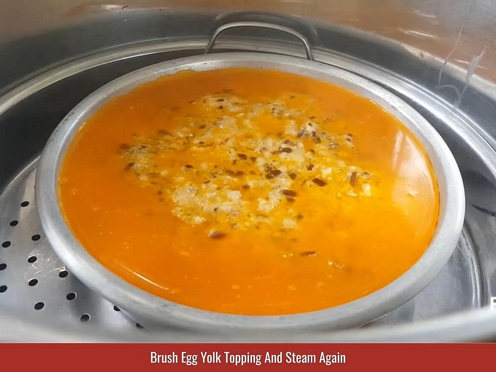 Add The Egg Yolk Topping
Whisk the 3 reserved egg yolks with the annatto oil and fish sauce until smooth. Brush the mixture evenly over the steamed meatloaf. Cover and steam for 5 additional minutes. Remove the meatloaf from the steamer and let it cool completely before unmolding and slicing.