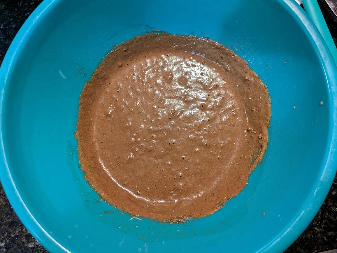 Add in dry ingredients, and mix with a silicone spatula until fully combined - almond flour, whey, cocoa powder, baking powder, baking soda, and salt.