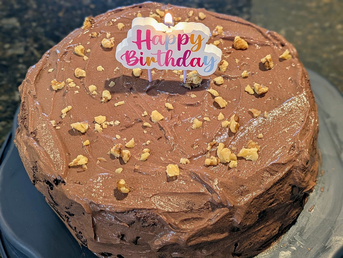 Remove the 2 cakes from their pans. Spread about 1/3 of your frosting (~120 g) onto one cake. Top with the other cake. Frost the top and the sides of the cake.