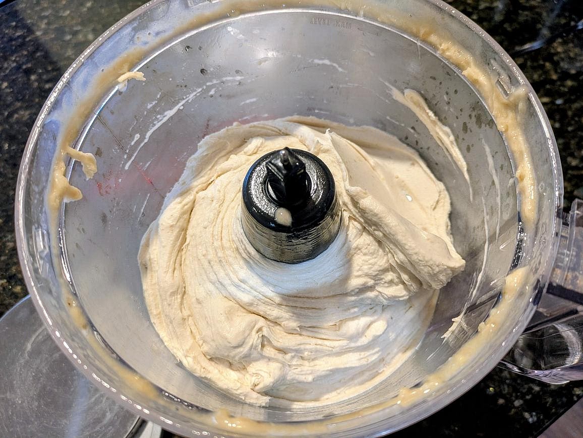 Add frozen bananas, almond milk, vanilla extract, and salt to a food processor. Blend for about 3-5 minutes, scraping the sides every minute or so, until you have a smooth and creamy ice cream.
