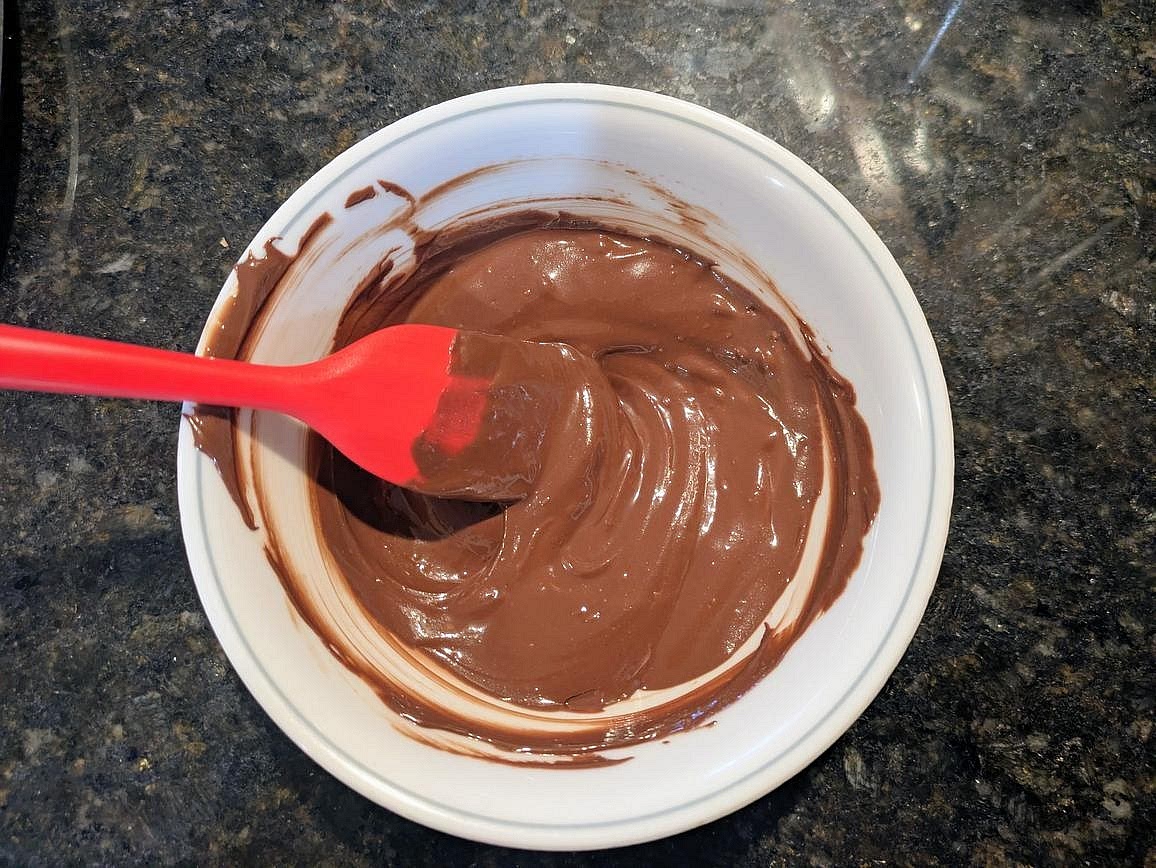 Add chocolate chips and coconut oil to a small microwave safe bowl. Microwave in 30 second intervals, stirring in between with a silicone spatula, until fully melted.