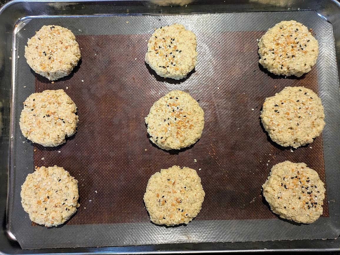 Divide the dough into 9 equal pieces, about 68 g each. Roll into a ball, place on the cookie sheet, lightly flatten, and shape into a circle. Optionally sprinkle the tops with everything bagel seasoning.