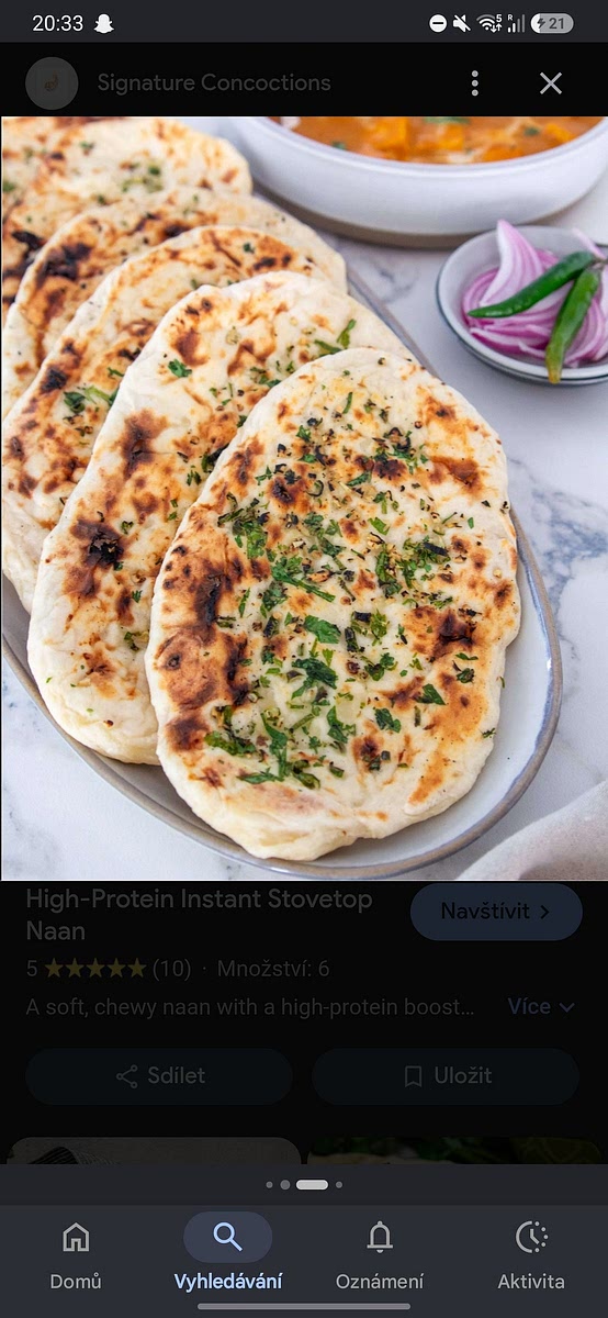 Heat a cast-iron skillet over high heat. Place the naan on the hot pan until large bubbles form and the bottom is golden (about 1 minute), then flip and cook the other side. Brush with melted butter or garlic butter before serving.