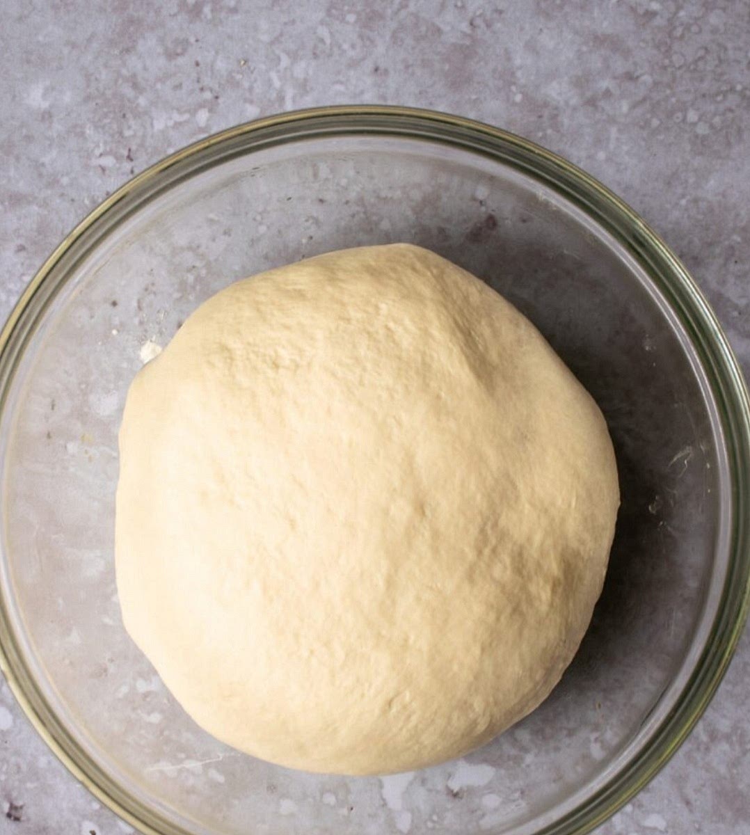 Combine flour, yeast, sugar, and salt. Stir in the yogurt, melted butter, and lukewarm water to form a soft dough.