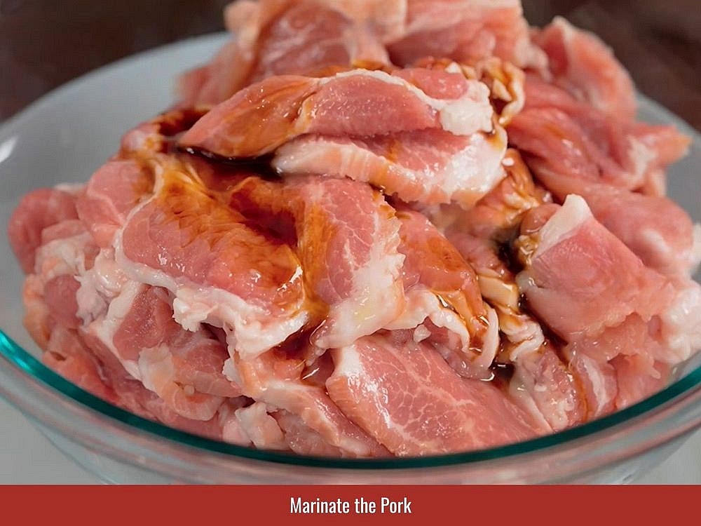 Combine minced lemongrass, shallots, garlic, fish sauce, sugar, salt, pepper, sesame oil, and bouillon powder. Coat the pork evenly with the marinade.
