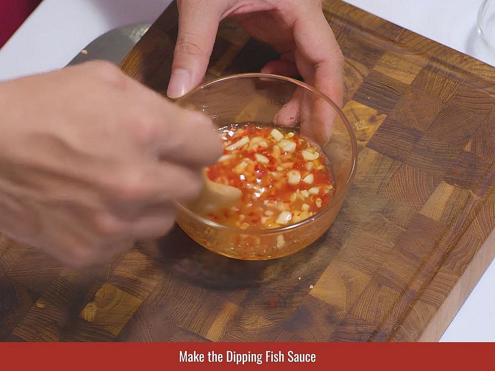 Mix fish sauce, sugar, lime juice, and water until balanced. Add minced garlic and sliced chili for aroma and heat.