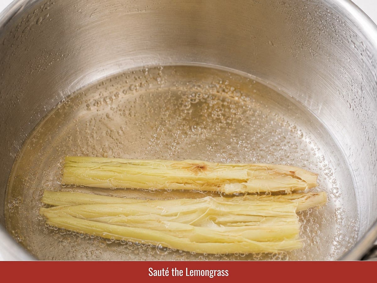 Heat oil and sauté bruised lemongrass until fragrant. Add garlic, shallot, and curry leaves, then cook until aromatic.