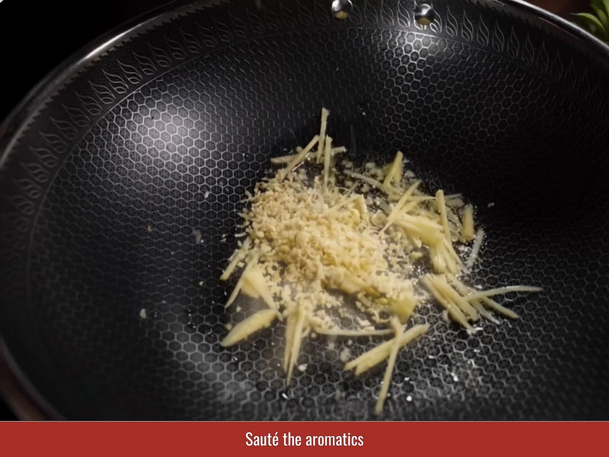 Heat oil in a wide pan or clay pot. Add ginger strips, lemongrass, shallots, and garlic, then cook until fragrant and lightly golden.