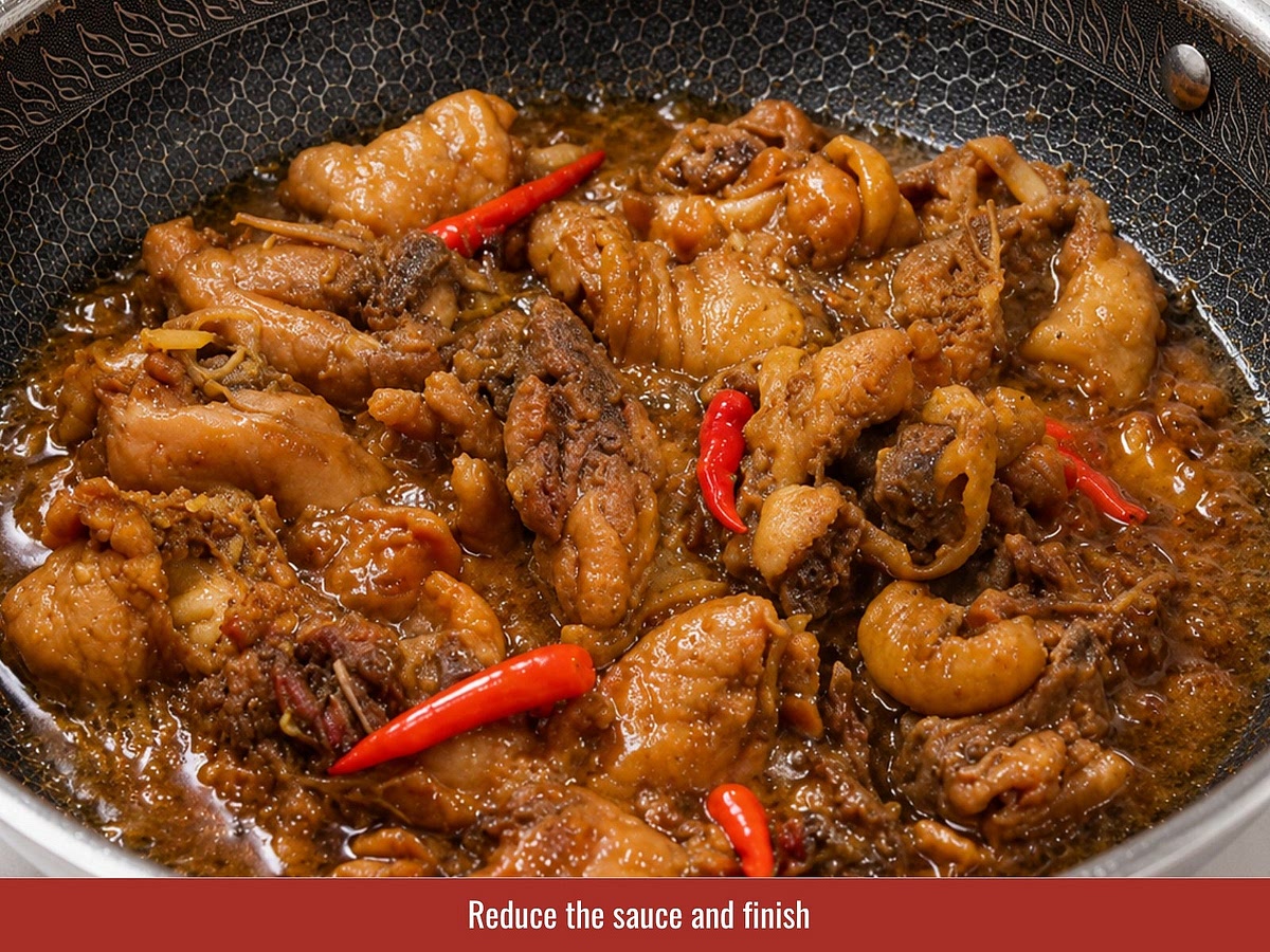 Remove the lid and continue simmering until the sauce reduces into a glossy coating that clings to the chicken. Add chili peppers and fresh ginger strips before finishing.