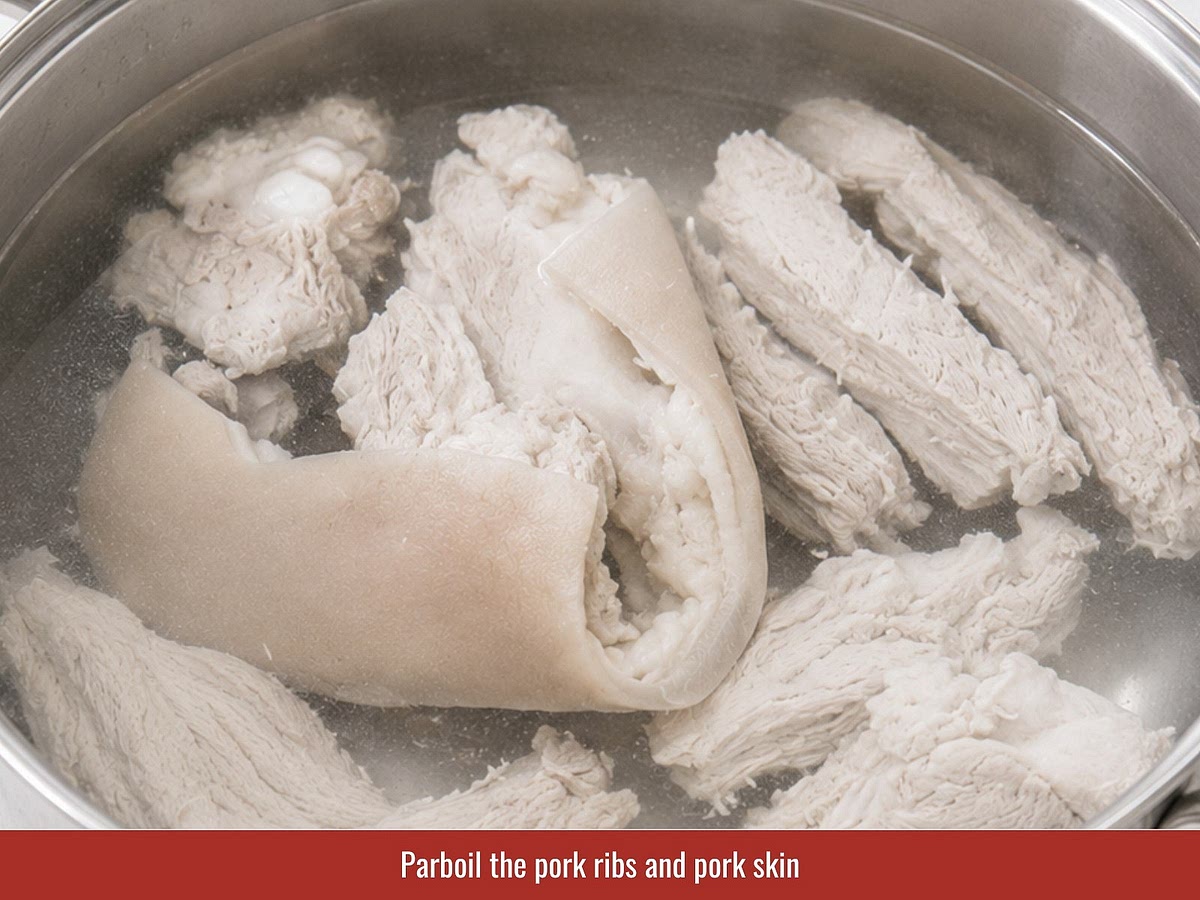 Return cleaned pork ribs and pork skin to the pot with fresh water. Simmer gently while removing foam to create a clear and sweet broth.