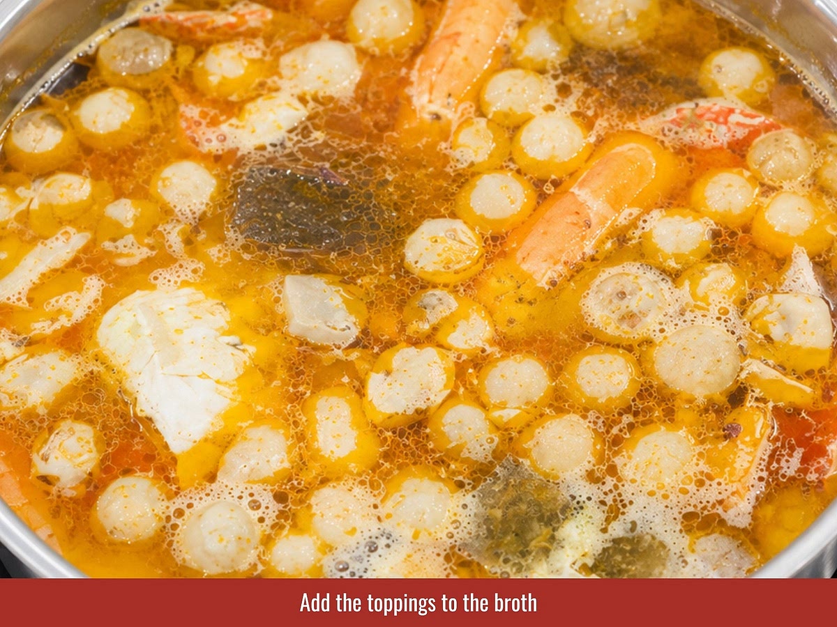 Remove onion, daikon, and aromatics from the broth after simmering. Add sautéed crab, shrimp, pork skin, blood cake, quail eggs, mushrooms, and crab roe.