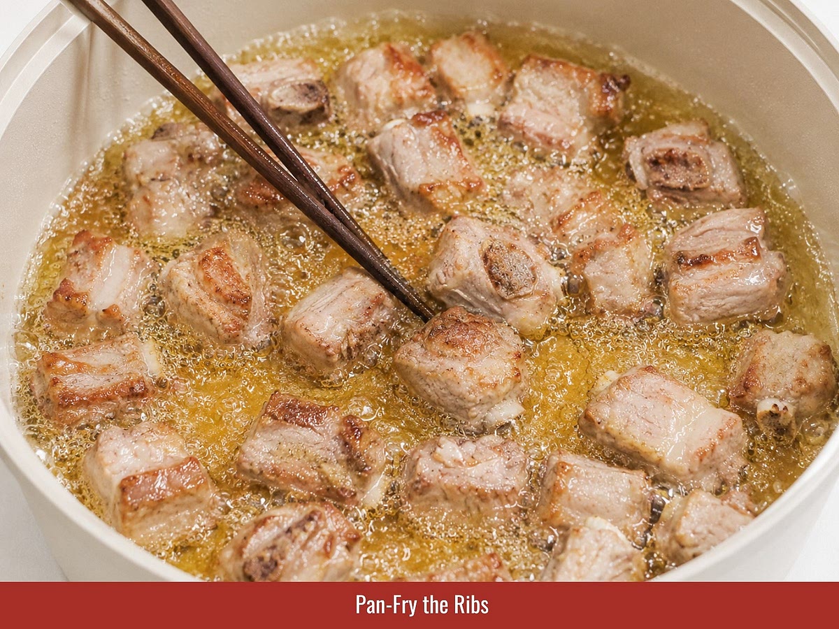 Pat the ribs completely dry. Fry them in hot oil until all sides become golden brown, then remove them from the pan.