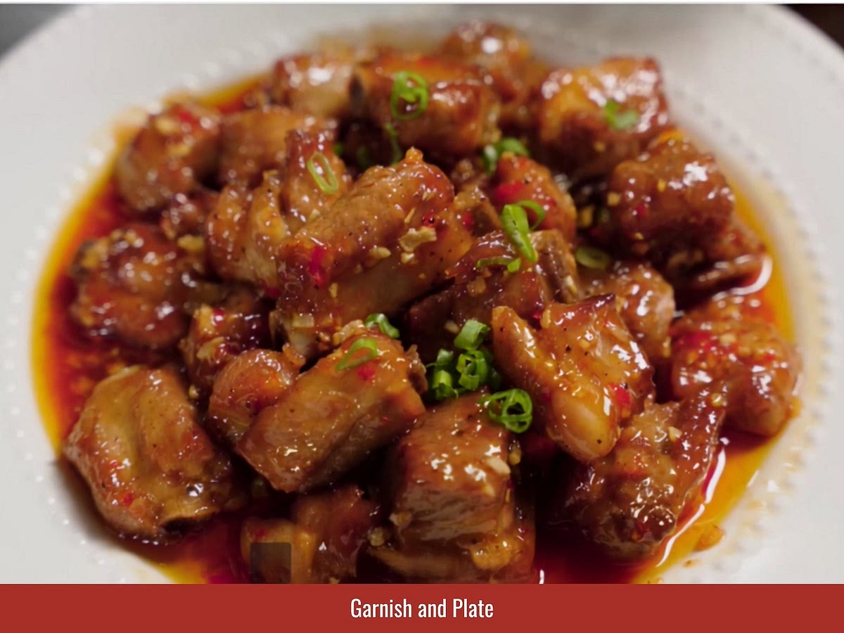 Add crispy garlic chips, sliced green onion tops, and black pepper. Transfer the ribs to a serving plate and serve immediately.
