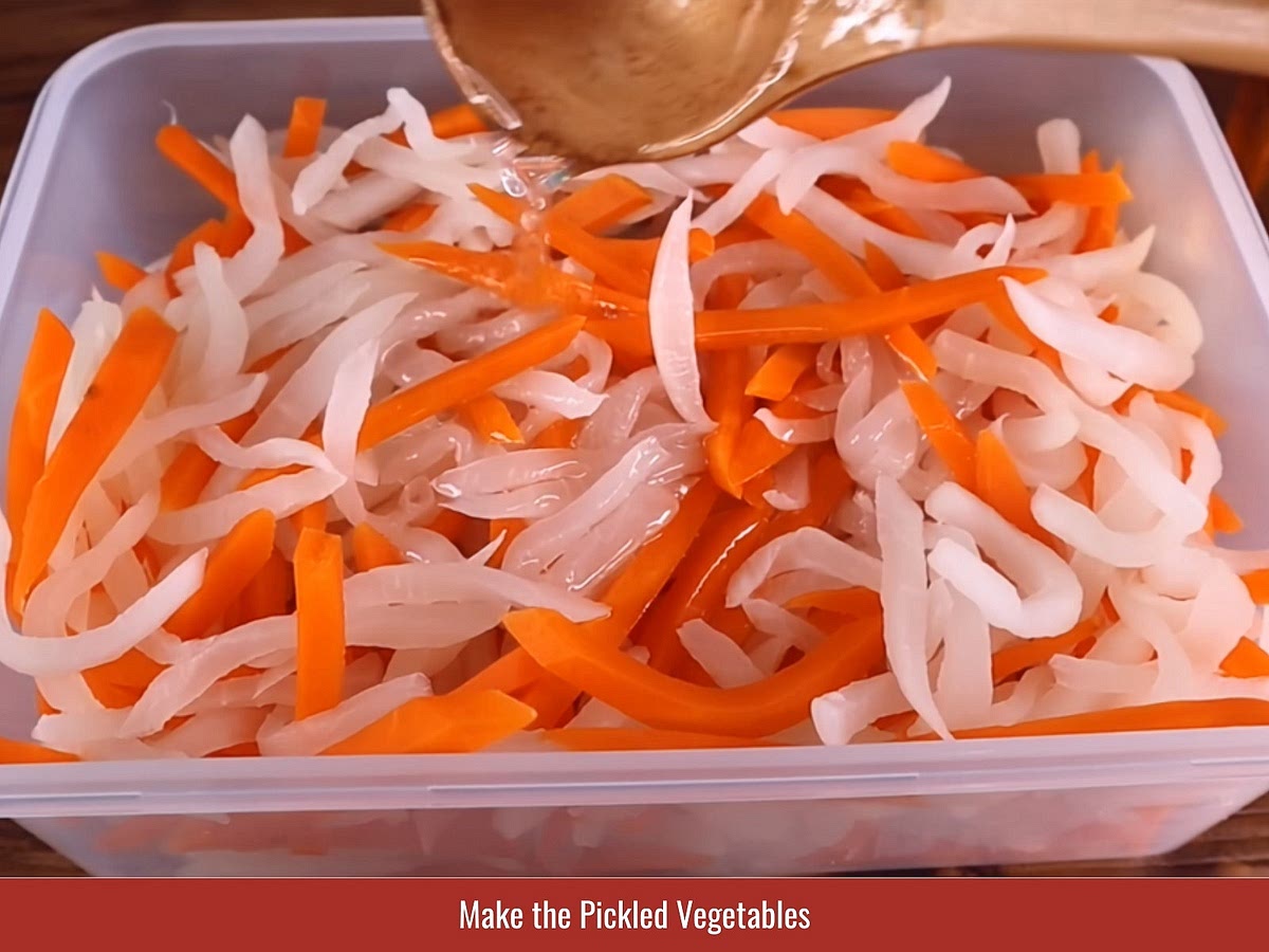 Cut daikon and carrot into thin strips. Salt briefly, rinse, then soak in rice vinegar, warm water, and sugar mixture until lightly pickled.