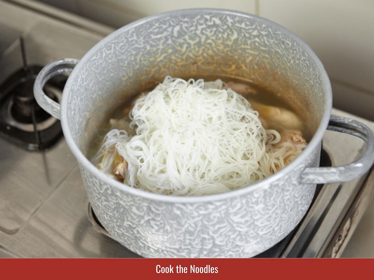 Separate fresh rice vermicelli and prepare lettuce, cucumber, bean sprouts, herbs, and crushed peanuts for assembling the bowls.