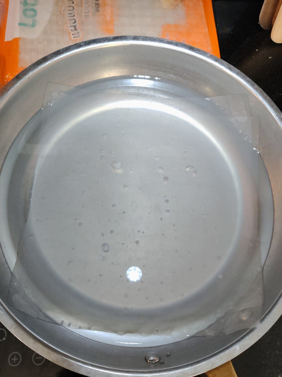 Wet a sheet of rice paper and add the filling. Top with another sheet of rice paper.