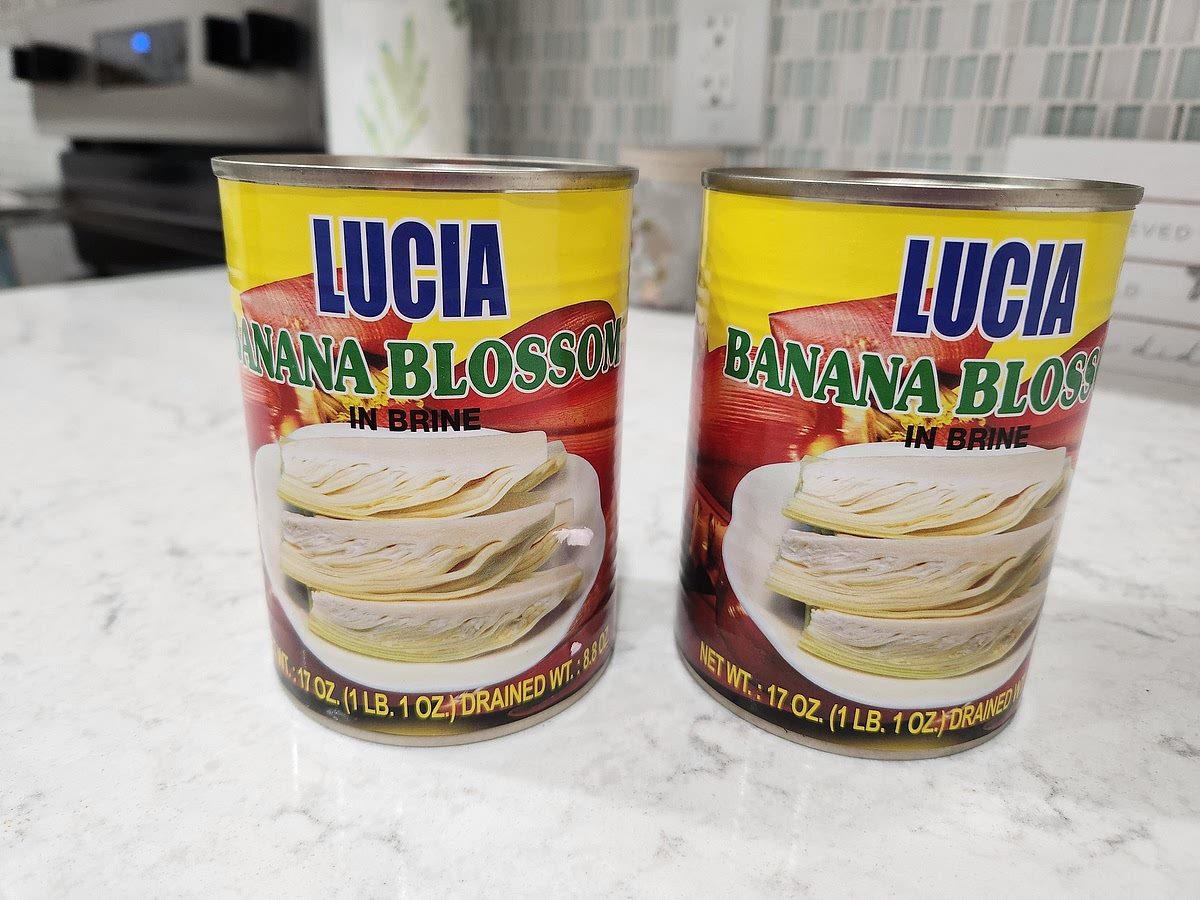 Alternatively, you can use 2 big cans of banana blossom for 5 salmon patties. Each can is 17oz / 1 lb 1 oz / 623g. I used Lucia brand banana blossoms, drained them, rinsed them, and put them in a plastic bowl. I used a fork and butter knife to cut/tear them up a bit before using my hands to squeeze out all the liquid. I moved the bowl over to the sink so I could drain it several times as I squeezed out the liquid. For the other ingredients, I went heaping on the crackers and flour, added a dash of salt, drizzled a little brine from a jar of capers, and added enough olive oil to moisten and form patties that hold together. These brown a little easier than usual, but appearances are deceiving! They may look "burnt" but they do not taste like it! Very tasty banana blossom salmon patties. I served mine with canned peas.