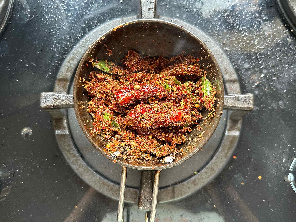 Add the masala that’s been prepared and cooled. Ensure that the flame is kept very low so that the masala does not burn.