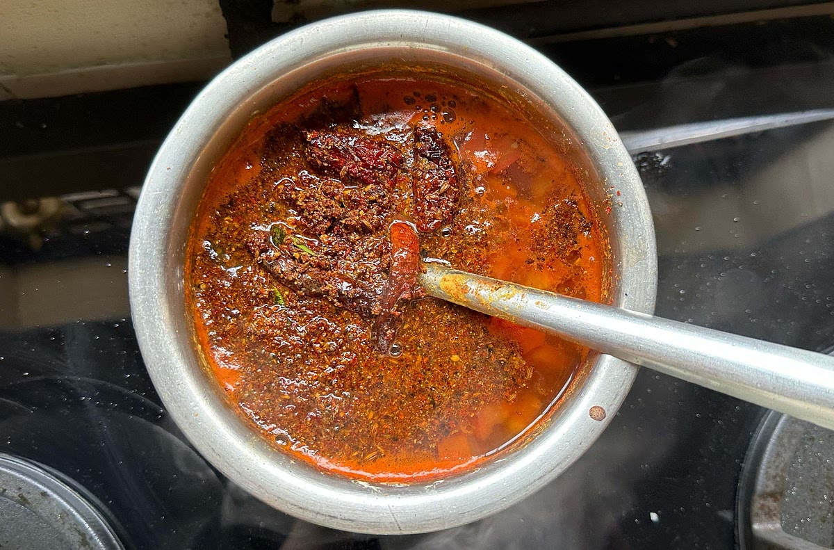 Pour this cooked masala into the kadhai where the rasam has boiled. Immediately cover with a lid to ensure the aroma remains.