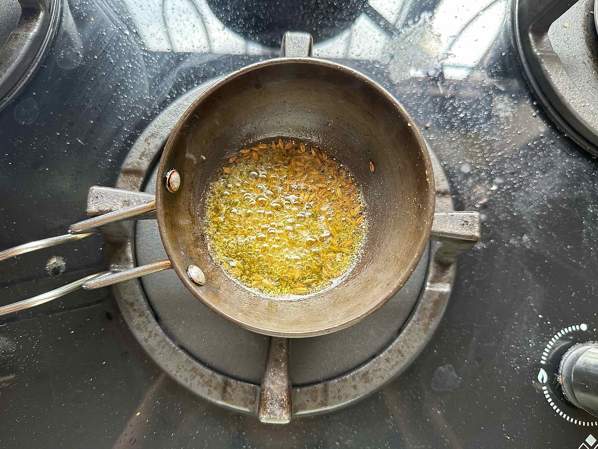 Add mustard seeds, cumin seeds, fenugreek seeds, and hing (in this order).