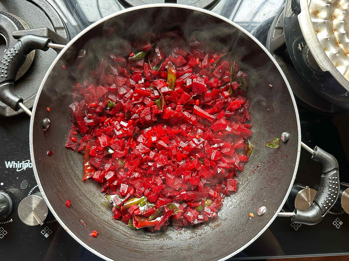 Add 1 glass of water to the kadhai so that the beetroot cooks well. Keep a lid on the kadhai while it cooks. This usually takes 10-12 minutes.