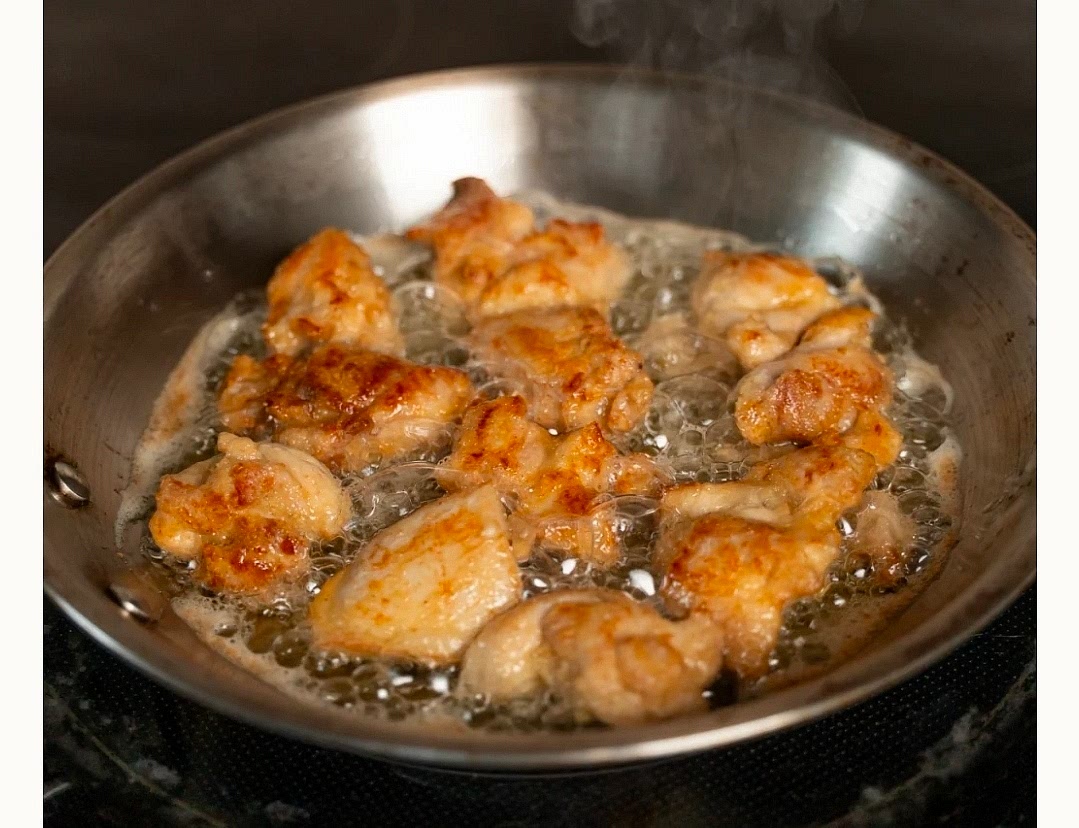 Heat a pan over medium-high heat with a few tablespoons of oil. Add chicken in an even layer without overcrowding. Cook for 6 to 7 minutes, turning as needed, until golden brown, crispy, and fully cooked through