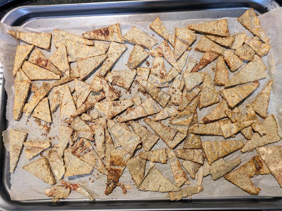 Cut your large tortilla into small triangles, about 96 chips. Season on the cookie sheet with oil and spices.