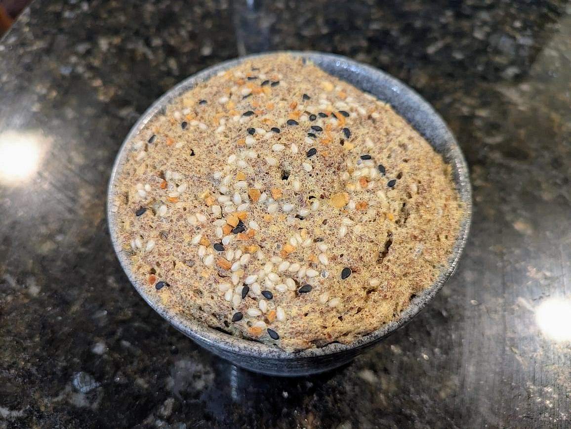 Microwave for 60-90 seconds, or until the top and sides are set. Let cool for a minute before removing and slicing in half.