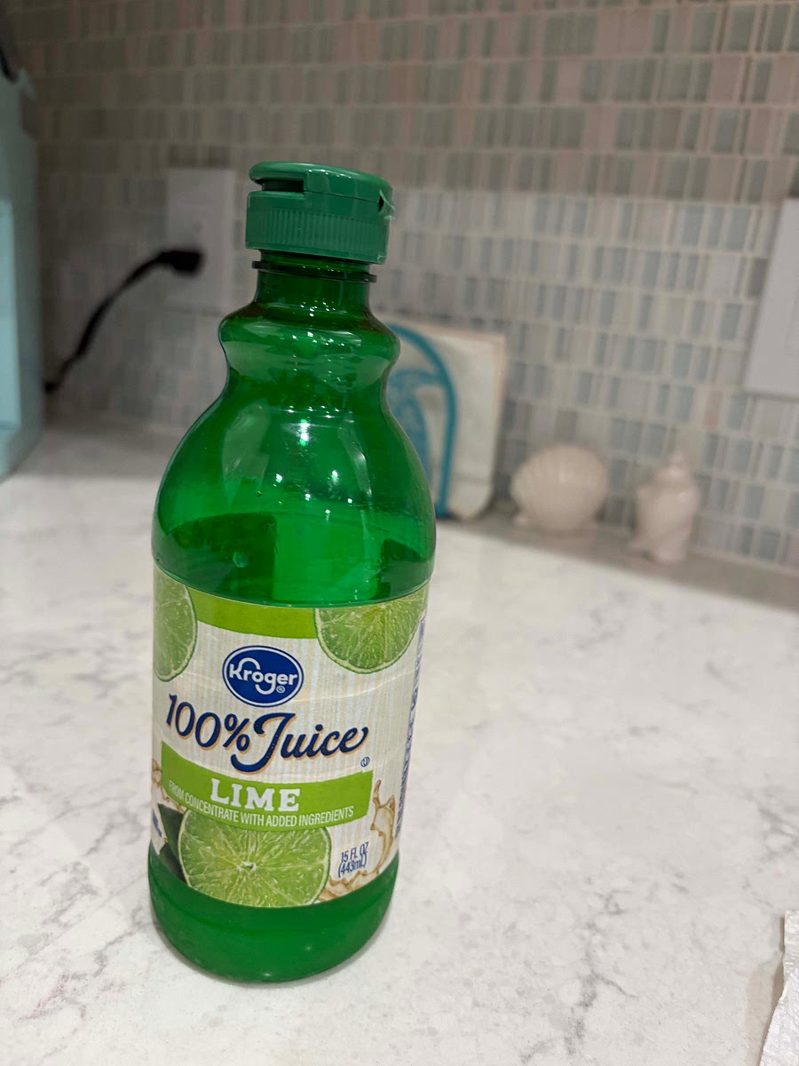 Add splash of sparkling water. Add 2 drops of lime juice. Add 1 mint leaf and stir with butter knife.