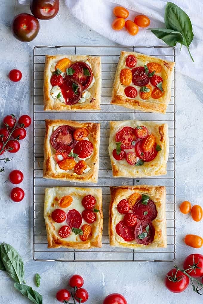 Prep the Oven and PastryPreheat your oven to 400°F (200°C) and line a large baking sheet with parchment paper.Unroll your puff pastry sheet and cut it into 6 equal rectangles.Dry the TomatoesLay your tomato slices on a paper towel.Sprinkle them with a pinch of salt and let them sit for 5 minutes.Blot the tops with another paper towel to remove extra moisture so your tarts don't get soggy.Build the Bases (Upside Down!)On your lined baking sheet, create 6 separate spots for your tarts.At each spot, drizzle about 1/2 teaspoon of olive oil and a tiny pinch of pepper.Place one tomato slice directly on top of each oil drizzle.Scoop 1 tablespoon of pimento cheese right onto the center of each tomato.Cover with PastryPlace a pastry rectangle over each tomato and cheese pile.Use a fork to gently press the edges of the pastry down against the parchment paper to seal the ingredients inside.Brush the top of the pastry with the beaten egg wash to help it get shiny and golden.Bake and FlipBake for 15 to 20 minutes until the pastry is puffed up and deeply golden brown.Remove from the oven and let them cool for just 2 to 3 minutes.Carefully slide a spatula under the pastry and flip each tart over so the tomato is now on top.
