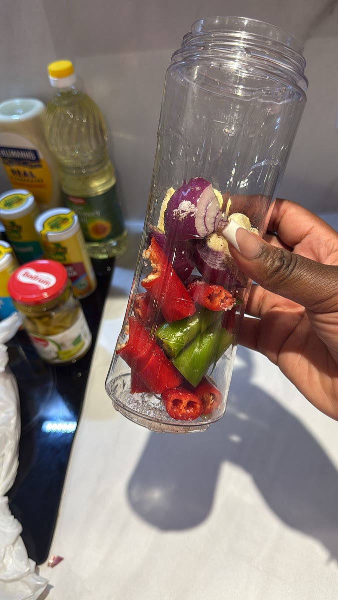 Add the long chillies, red onion, garlic, salt, black pepper, cider vinegar, ground coriander and dried parsley to a blender.
