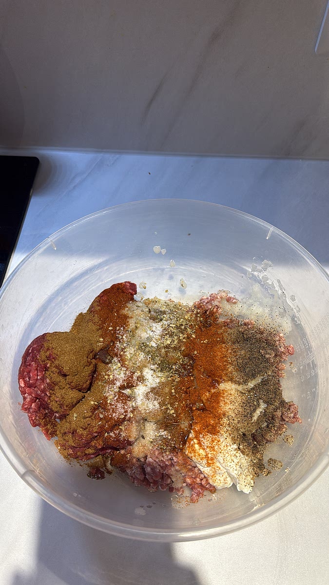 Add the 500g beef mince and 500g lamb mince to a large bowl. Pour in your blended onion, then add: Greek yoghurt, garlic paste, ground cumin, ground coriander, oregano, smoked paprika, black pepper, chilli powder/cayenne, salt and a little oil.