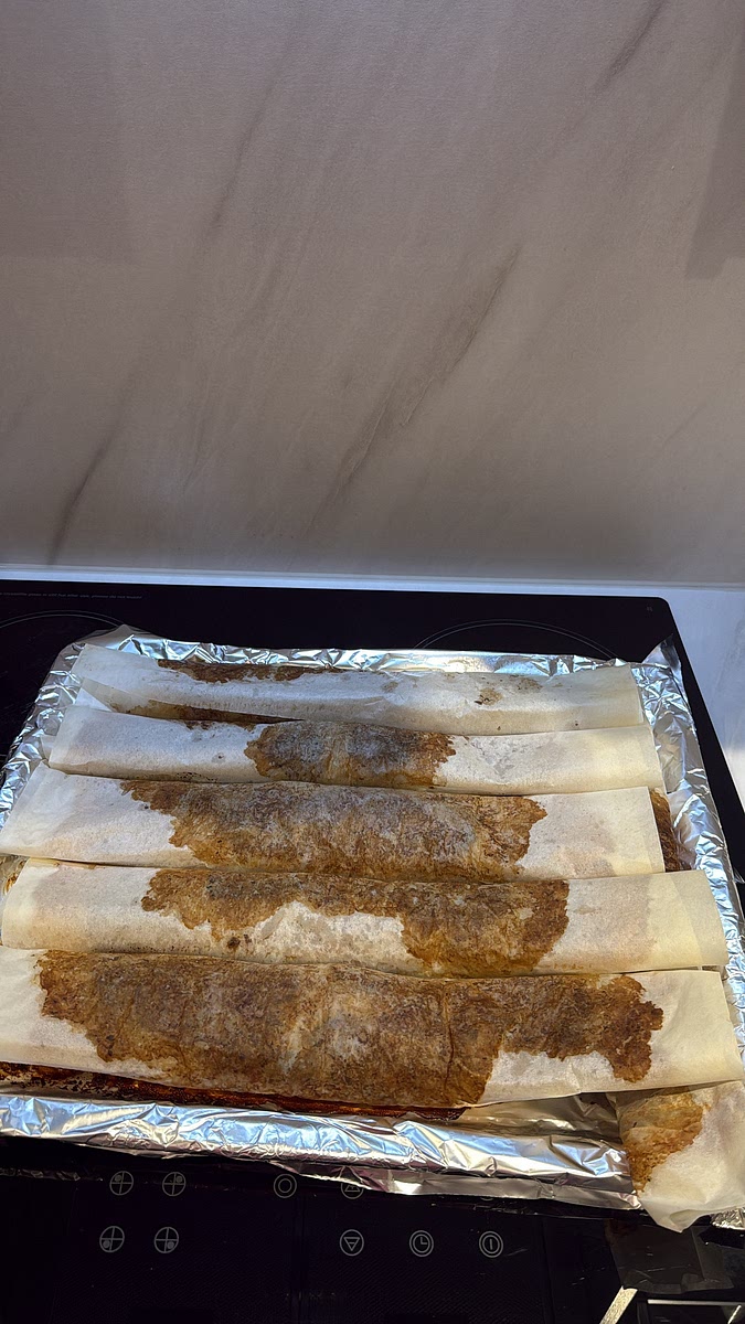 Place the rolls onto a lined baking tray. Bake at 180–200°C for approximately 30–40 minutes, making sure the meat is thoroughly cooked through. Once cooked, unwrap the rolls and separate/cut the doner into strips.