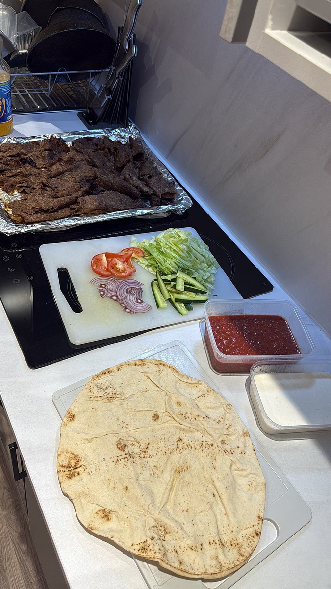 Warm your khobez/flatbread, then layer everything down the centre