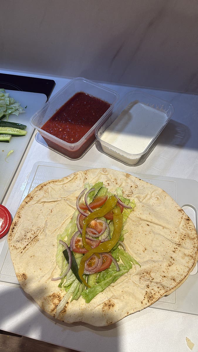 Lettuce → cucumber → tomato → red onion → pickled peppers salt and pepper