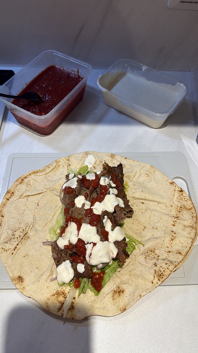 DONER MEAT → chilli sauce → garlic sauce. Fold the sides over and roll it up tightly. Wrapping the bottom in foil makes it sooo much easier to eat.