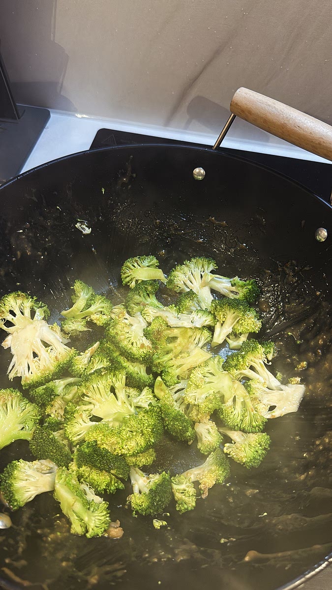 Add the washed and chopped broccoli to the same wok. Stir-fry until it becomes bright green and slightly tender, but don’t overcook it — we still want a little crunch.