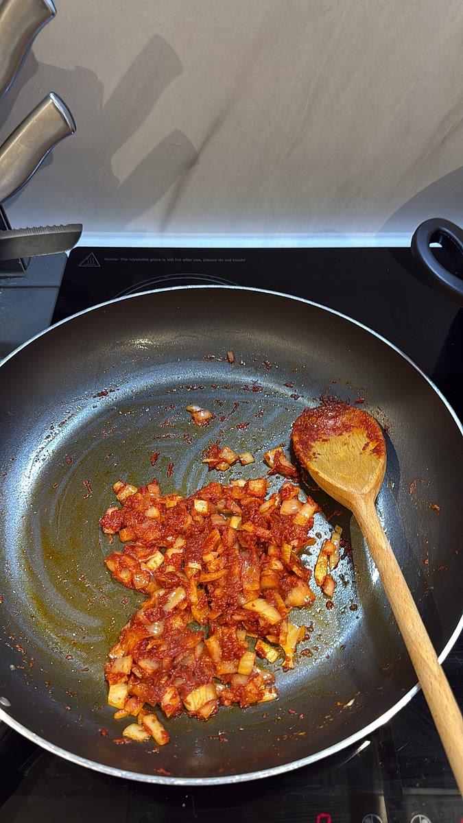 Add your: * All-purpose seasoning
* Cajun seasoning
* White pepper
* Garlic powder
* Salt Mix everything together and let those seasonings cook into the tomato base.