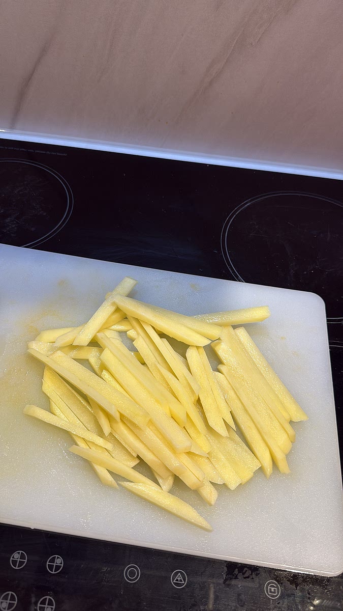 Peel the potatoes and slice them into thin fries. Rinse off the excess starch and pat them completely dry before frying.