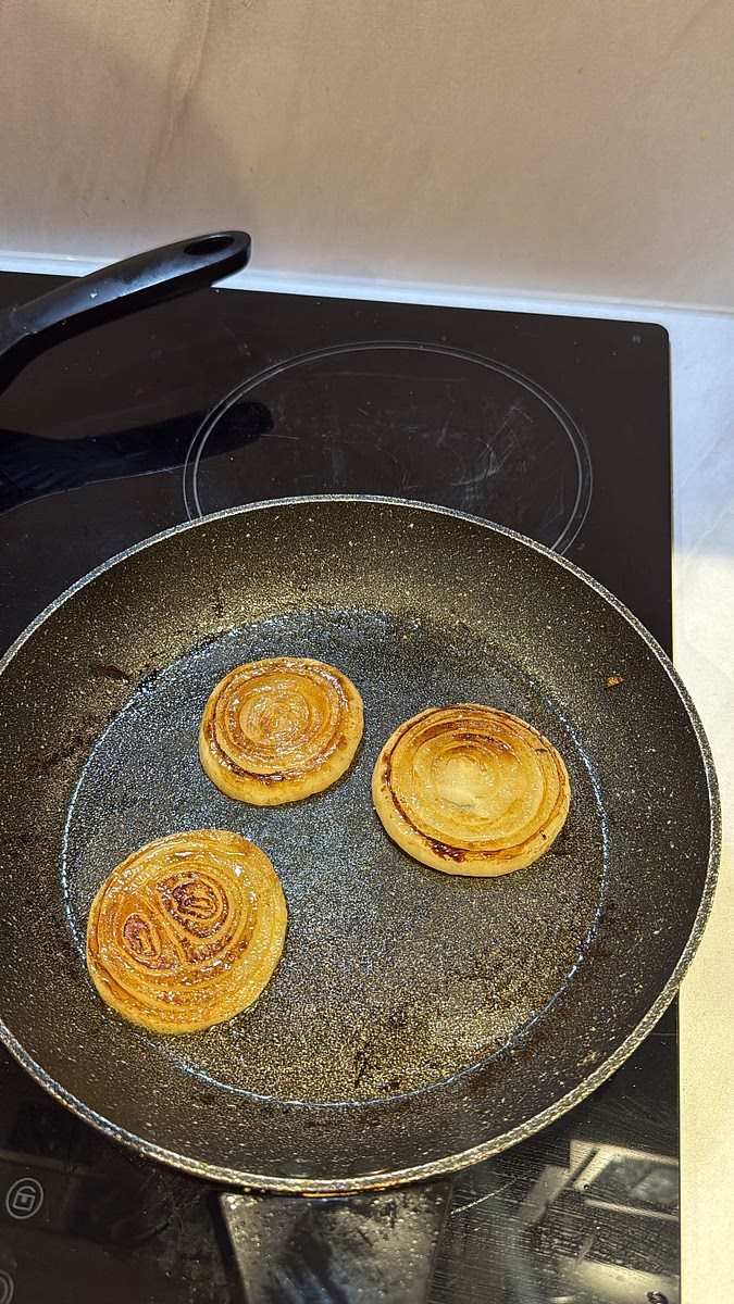 Add the thick onion rounds to a lightly buttered pan and cook over medium heat until beautifully golden and caramelised on both sides while still holding their shape. Set aside.