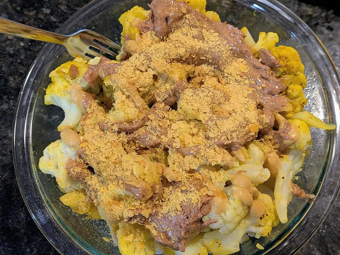 Finally, top each bowl with 2 tbsp + 1 tsp (75 g) nut butter, 2 tbsp (30 g) red wine vinegar, 2 tbsp (30 g) dijon mustard, and 1 tbsp (5 g) nutritional yeast. Store in the fridge for up to 1 week.