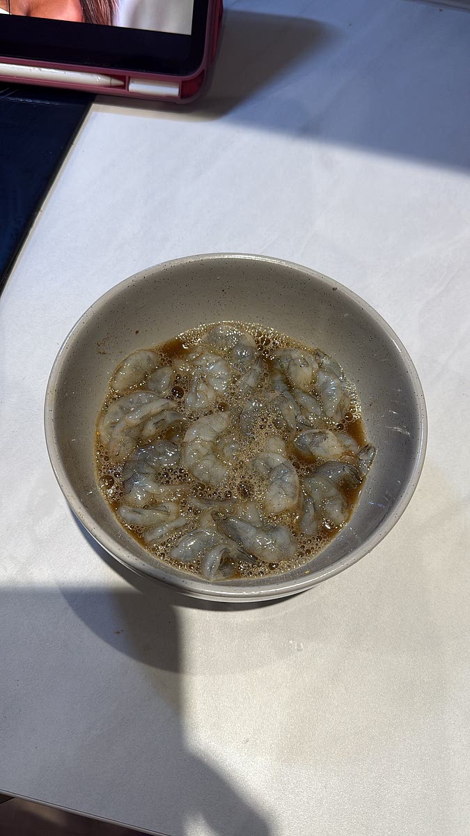Add the prawns to a bowl with the MSG, salt, light soy sauce, garlic powder, Chinese five spice and white pepper. Pour in the egg white and mix thoroughly so every prawn is coated. This helps create that light, crispy exterior. Mix until everything is evenly coated.