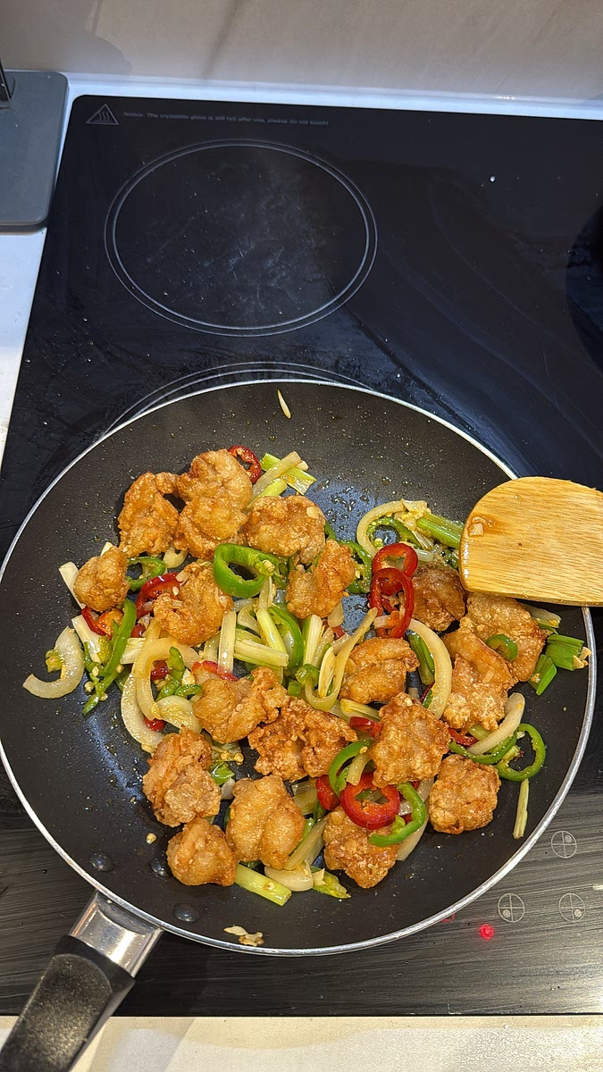 Add the crispy prawns back into the pan. Season lightly with salt, MSG and white pepper, then toss everything together for about 1–2 minutes until the prawns are coated in all that chilli-garlic goodness.