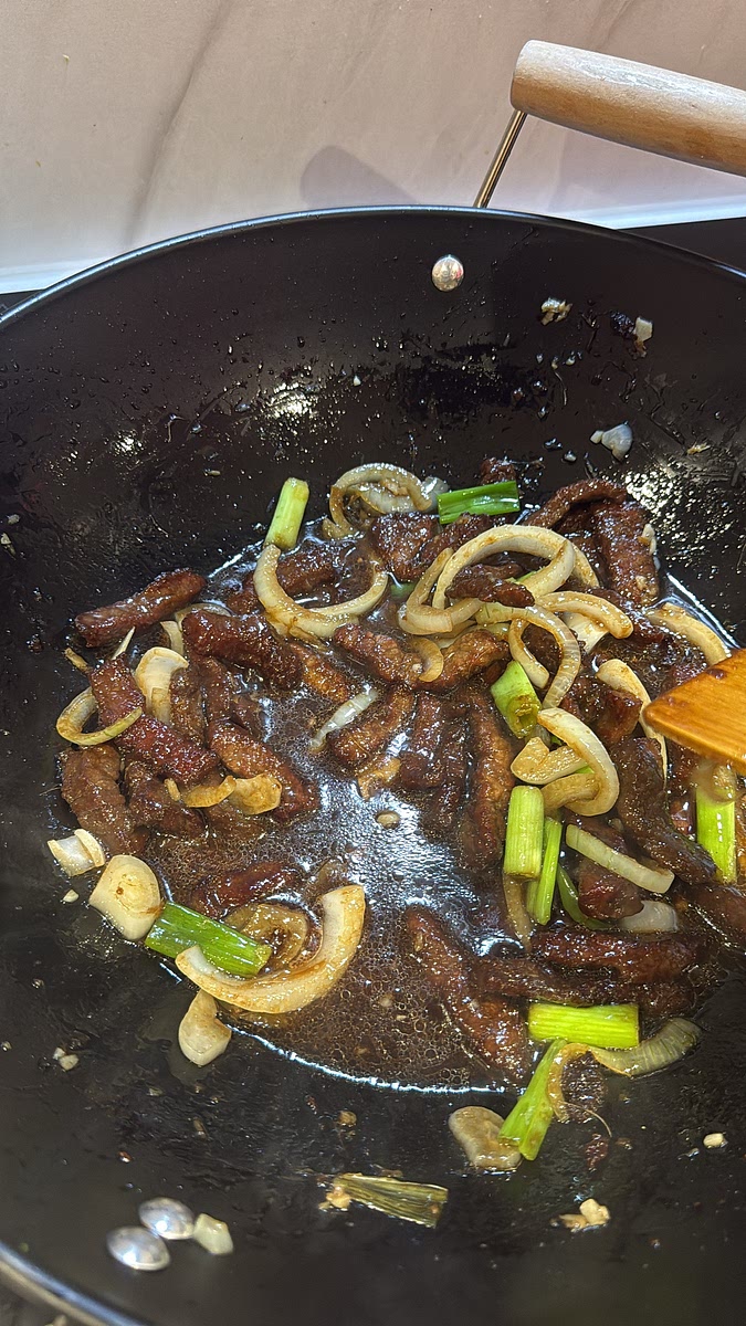 Pour in your prepared sauce and toss everything together over medium-high heat. Allow the sauce to bubble and reduce for around 3–5 minutes, stirring frequently, until it becomes darker, glossy and coats the beef.