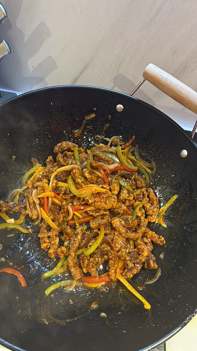 Add the crispy beef back in and toss quickly until every strip is coated. Don’t leave it sitting in the sauce too long or you’ll lose that crispiness.