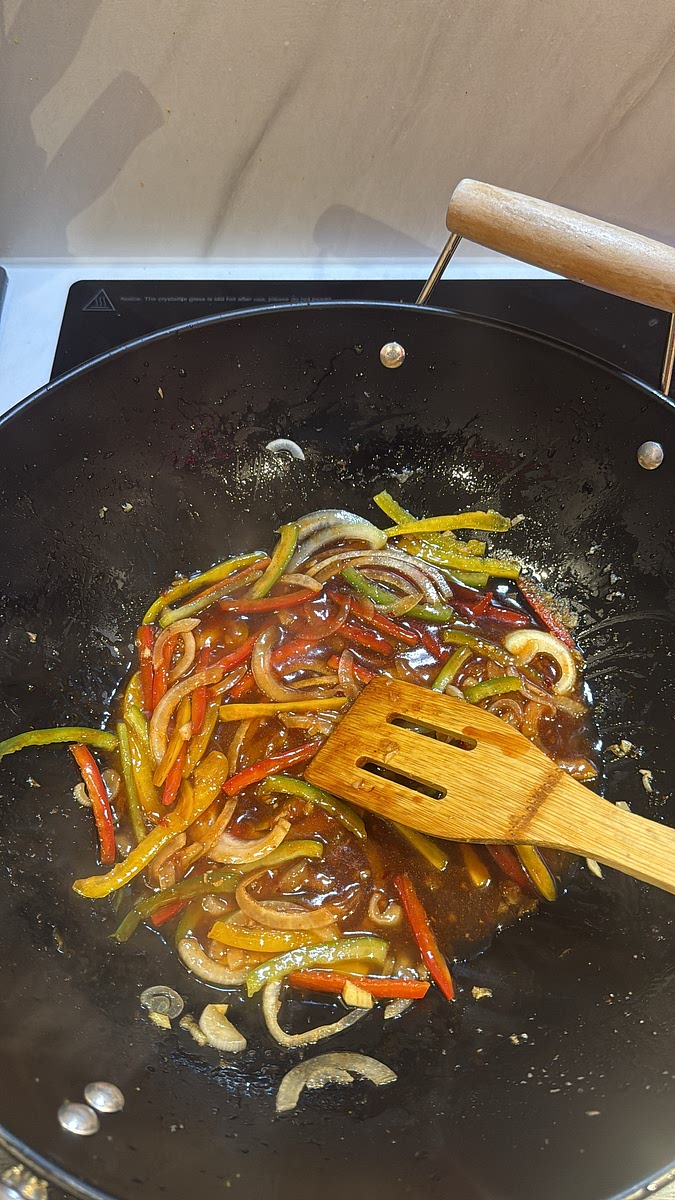 Pour in your sauce and let it bubble for 1–2 minutes until glossy and slightly thickened.